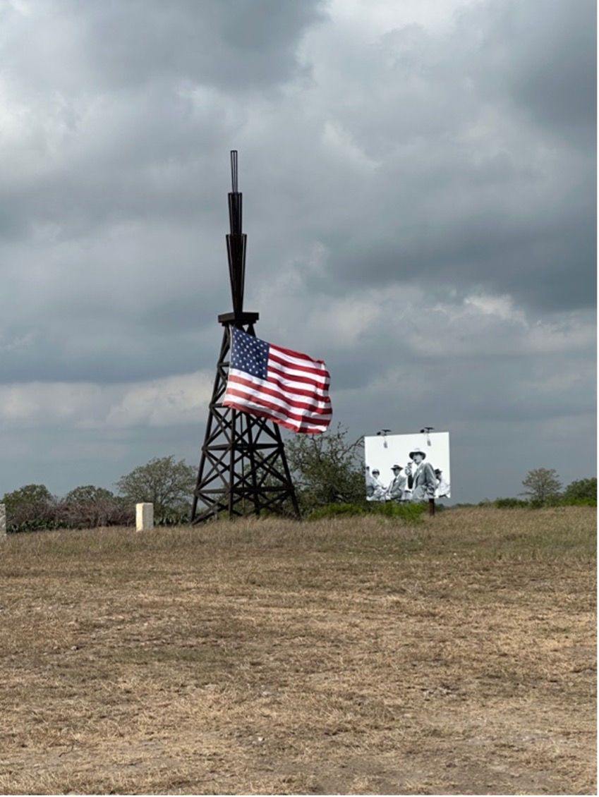 Oppenheimer next to the highest American flag I've ever seen on private property.